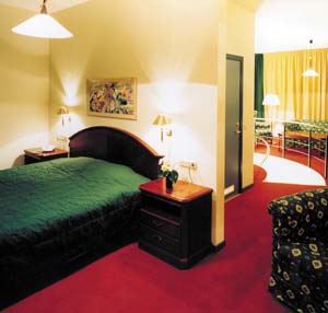 2 person deluxe 2 room suite and 2 children with city view, balcony, an extra bed, private facilities (bath and shower), and breakfast